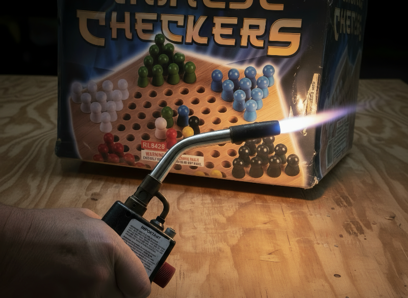 Image of a 500 gram fireworks cake being lit with a torch