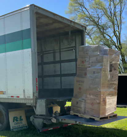 A shrink-wrapped pallet of Fireworks being lowered on a semi truck's liftgate signifying a caution about extra freight fees charged by freight companies.