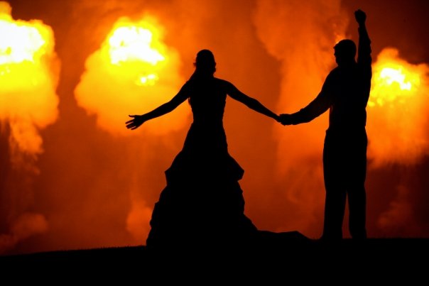 A happy couple watching fireworks at their wedding.